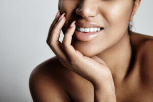 A smiling woman with clear skin after infusion therapy