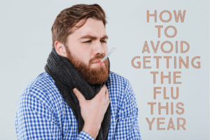 A man taking his temperature while sick with the flu