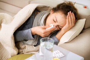 A person sick with the flu laying on a couch